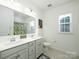 Well-lit bathroom featuring dual sinks, a large mirror, and a bathtub-shower combination at 611 Yucatan Dr, Waxhaw, NC 28173
