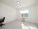Minimalist bedroom with neutral carpeting, bright natural light, and simple gold side table at 611 Yucatan Dr, Waxhaw, NC 28173