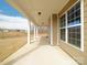 A long and well-lit covered patio providing outdoor living space and view of the yard at 611 Yucatan Dr, Waxhaw, NC 28173