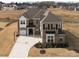 Elegant brick home with a manicured lawn, large driveway, and attached two-car garage at 611 Yucatan Dr, Waxhaw, NC 28173