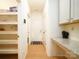 Hallway with pantry shelving, granite countertop desk, and wood flooring at 611 Yucatan Dr, Waxhaw, NC 28173