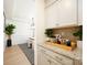 Hallway with counter, cabinets, decorative tile backsplash and view into the dining room at 611 Yucatan Dr, Waxhaw, NC 28173