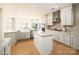 Bright kitchen featuring granite countertops, stainless steel appliances, an island, and hardwood floors at 611 Yucatan Dr, Waxhaw, NC 28173