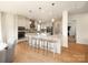 Bright, spacious kitchen with stainless steel appliances, granite countertops, pendant lights, and a large center island at 611 Yucatan Dr, Waxhaw, NC 28173