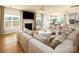 Bright living room with a fireplace, large windows, and a plush sectional sofa with a view of the kitchen at 611 Yucatan Dr, Waxhaw, NC 28173