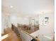 Open loft area with hardwood floors, chandelier, and railings at 611 Yucatan Dr, Waxhaw, NC 28173