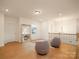 Second floor loft area with wood floors, comfortable seating, and plenty of natural light at 611 Yucatan Dr, Waxhaw, NC 28173