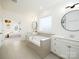 Bright main bathroom featuring a soaking tub, white cabinets, and dual vanities at 611 Yucatan Dr, Waxhaw, NC 28173