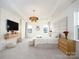 Bright main bedroom offers modern light fixture, television, and multiple windows at 611 Yucatan Dr, Waxhaw, NC 28173