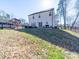 A sprawling backyard featuring a well-maintained lawn, contemporary patio furniture, and a sleek, charcoal grill at 1004 Loganberry Ln, Salisbury, NC 28146