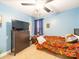 Blue bedroom with single bed, dark wood furniture, and TV at 1004 Loganberry Ln, Salisbury, NC 28146