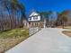 Inviting home featuring a long driveway and white picket fence at 1004 Loganberry Ln, Salisbury, NC 28146