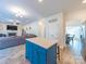 Open floor plan featuring kitchen island with blue cabinetry and open access to living and dining areas at 1004 Loganberry Ln, Salisbury, NC 28146
