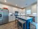 Bright kitchen features stainless steel appliances, white cabinetry, and an island with stool seating at 1004 Loganberry Ln, Salisbury, NC 28146