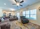 Spacious living room with large windows, comfortable seating, and an open connection to the kitchen at 1004 Loganberry Ln, Salisbury, NC 28146