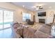 Open living room boasts a fireplace, a comfortable sofa, and sliding glass doors to the backyard at 1004 Loganberry Ln, Salisbury, NC 28146