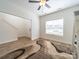 Bright living room with wood floors, a ceiling fan, and an adjacent staircase at 1004 Loganberry Ln, Salisbury, NC 28146
