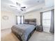 Spacious main bedroom with tray ceilings, large windows, and a cozy bed at 1004 Loganberry Ln, Salisbury, NC 28146