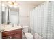 Bathroom featuring a vanity, toilet, and shower with a decorative curtain at 10142 Linksland Dr, Huntersville, NC 28078