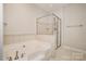 A relaxing bathroom featuring a soaking tub and a separate glass shower enclosure at 10142 Linksland Dr, Huntersville, NC 28078