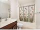 Neutral bathroom featuring a vanity sink, toilet, and tub-shower with a colorful butterfly shower curtain at 10142 Linksland Dr, Huntersville, NC 28078