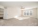 Light-filled bedroom with a ceiling fan and three windows providing ample natural light at 10142 Linksland Dr, Huntersville, NC 28078