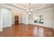 Elegant dining room with hardwood floors, stylish chandelier, and classic wainscoting at 10142 Linksland Dr, Huntersville, NC 28078