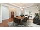 Elegant dining room with hardwood floors, stylish chandelier, and classic wainscoting at 10142 Linksland Dr, Huntersville, NC 28078