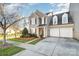 Inviting two-story home with a two-car garage, neat landscaping, and a well-manicured lawn at 10142 Linksland Dr, Huntersville, NC 28078