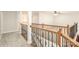 Second floor hallway with wood and wrought iron railing overlooking the lower level at 10142 Linksland Dr, Huntersville, NC 28078