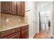 Convenient kitchen area featuring granite counters and wooden cabinets at 10142 Linksland Dr, Huntersville, NC 28078