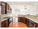 Open-concept kitchen featuring granite countertops, stainless steel appliances, and a breakfast bar at 10142 Linksland Dr, Huntersville, NC 28078