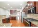 Spacious kitchen with stainless steel appliances, granite counters, and plenty of wooden cabinet storage at 10142 Linksland Dr, Huntersville, NC 28078