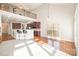 Living room showcasing kitchen access, loft, dining area, and natural light from large window at 10142 Linksland Dr, Huntersville, NC 28078