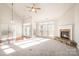 Bright living room with high ceilings, a ceiling fan, fireplace, and lots of natural light at 10142 Linksland Dr, Huntersville, NC 28078