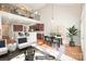Living room showcasing kitchen access, loft, dining area, and natural light from large window at 10142 Linksland Dr, Huntersville, NC 28078