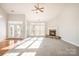 Bright living room with high ceilings, a ceiling fan, fireplace, and lots of natural light at 10142 Linksland Dr, Huntersville, NC 28078