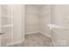 Spacious walk-in closet with carpet flooring and multiple wire shelving units at 10142 Linksland Dr, Huntersville, NC 28078