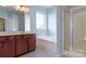Bright bathroom featuring a large vanity, tub, separate shower, and great lighting at 10546 Tintinhull Dr, Indian Land, SC 29707