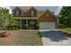 Charming two-story brick home with a well-maintained lawn and inviting curb appeal at 10546 Tintinhull Dr, Indian Land, SC 29707