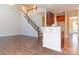 Open-concept living area with hardwood floors, a staircase, and view to the kitchen at 10546 Tintinhull Dr, Indian Land, SC 29707