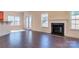 Spacious living room features hardwood floors, a cozy fireplace, and natural light at 10546 Tintinhull Dr, Indian Land, SC 29707