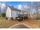 View of the backyard with a deck, storage shed, and well-maintained lawn surrounded by mature trees at 1275 Rocky Ridge Trl, Salisbury, NC 28146