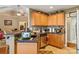 Practical kitchen featuring oak cabinets, tile floors, and a breakfast bar at 1275 Rocky Ridge Trl, Salisbury, NC 28146