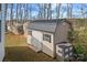 Backyard storage shed with double doors and a durable, metal roof with extra storage space, and a rock formation at 1275 Rocky Ridge Trl, Salisbury, NC 28146