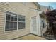 Home back entrance with a bright exterior door, windows, and cream siding at 1386 Walnut Hill Dr, Rock Hill, SC 29732