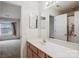 Bathroom vanity with a sink, wood cabinets, and a large mirror; leads to bedroom at 1386 Walnut Hill Dr, Rock Hill, SC 29732