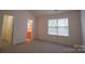 Bright bedroom featuring neutral carpet, large windows for natural light, and an ensuite bathroom at 1386 Walnut Hill Dr, Rock Hill, SC 29732
