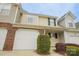 Charming townhome featuring a brick accent, a white garage door, and lush landscaping in a well-maintained community at 1386 Walnut Hill Dr, Rock Hill, SC 29732