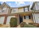 Attractive townhome features neutral siding, a brick accent, and a black front door at 1386 Walnut Hill Dr, Rock Hill, SC 29732